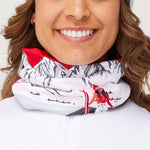 Krimson Klover Women's Apres Anyone Gaiter - A white gaiter with a red and gray mountain design, featuring a woman in a red jacket skiing down a slope.