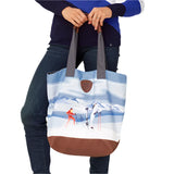 Krimson Klover Women's Illustrated Tote - A woman in a red snowsuit skiing down a mountain, illustrated on the front of this tote bag.