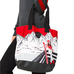 Krimson Klover Women's Illustrated Tote 2025 - A gray tote with a red and black illustration of skiers on the front.