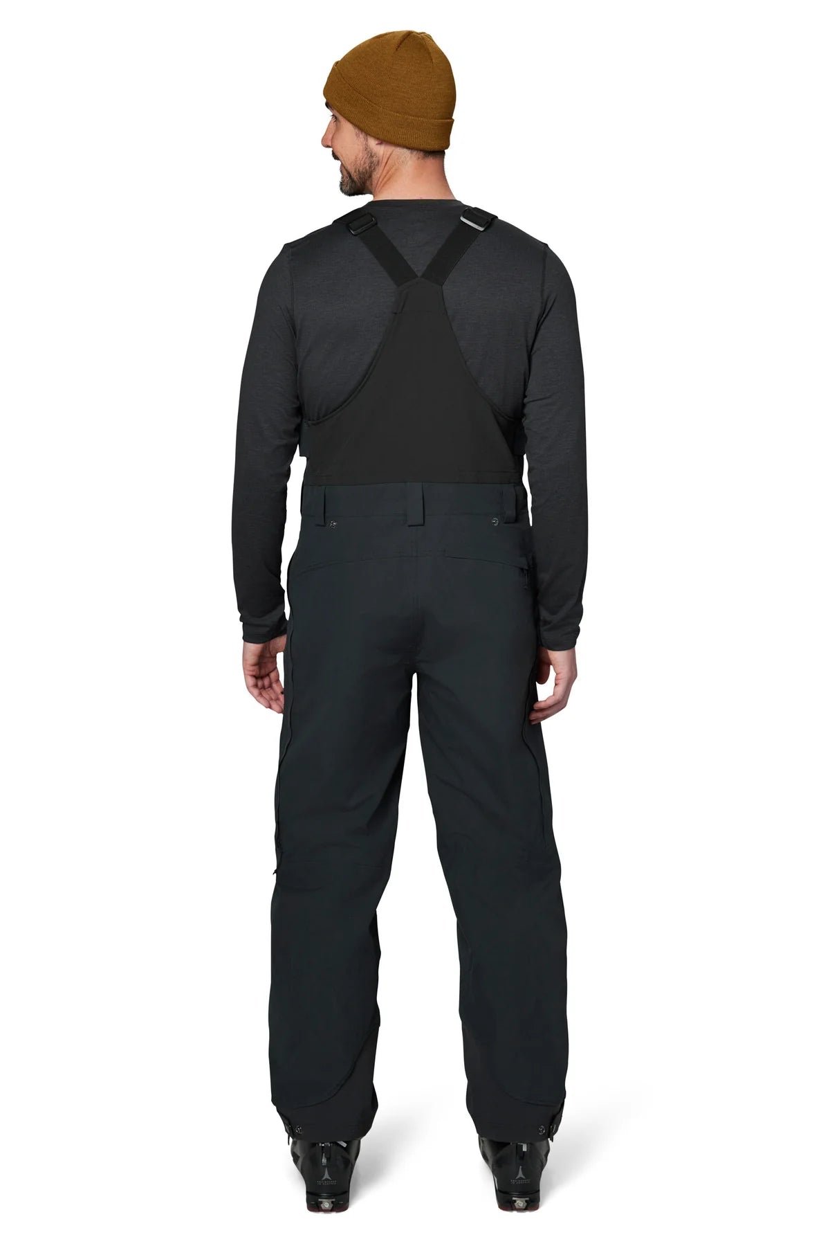 Flylow Firebird Bib 2025 - Black bib with black straps, zippered leg pockets, and a white logo on the left thigh.