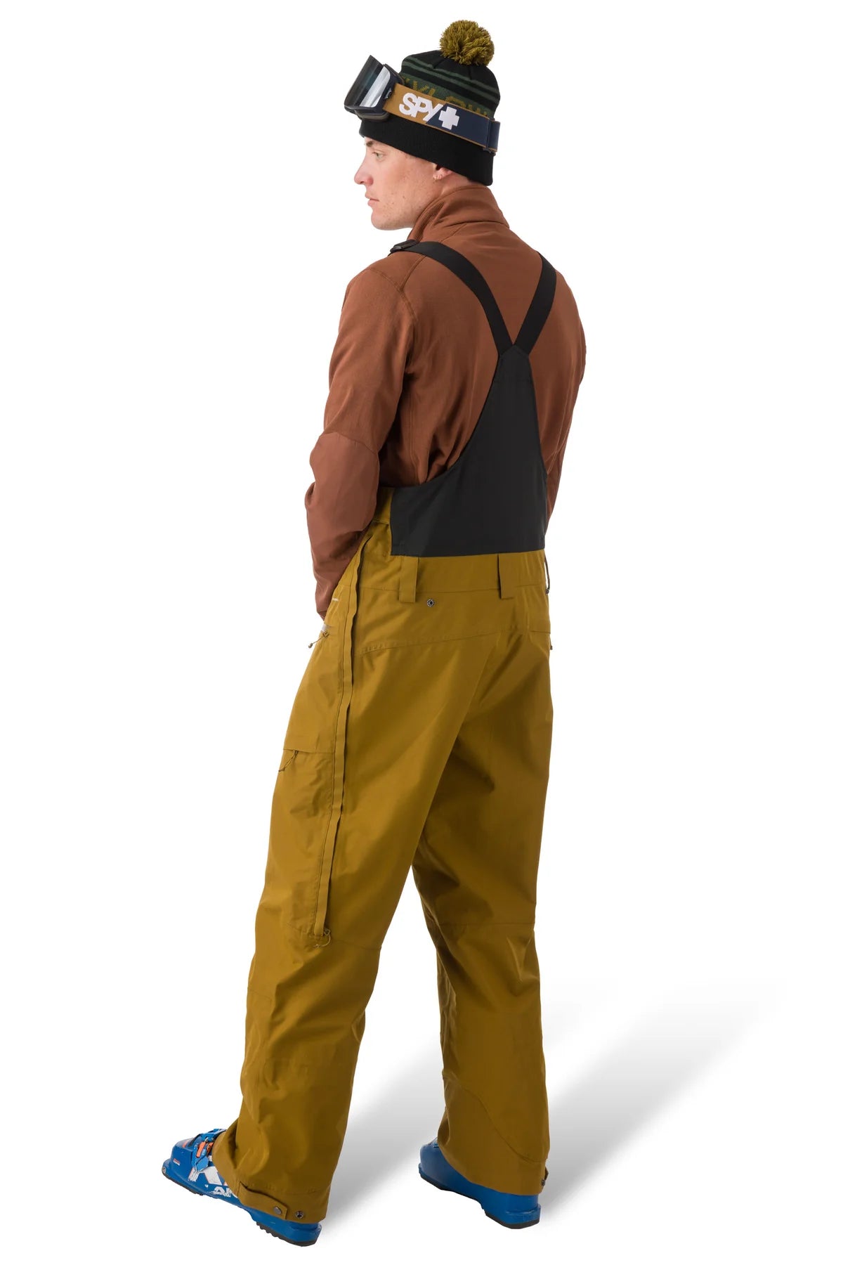 Flylow Firebird Bib - A pair of brown snow pants with a black logo on the left leg and a zippered pocket on the right thigh.