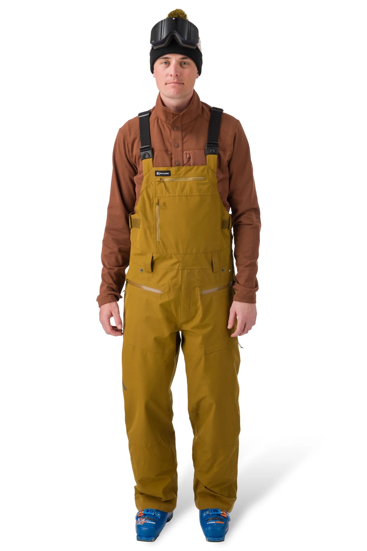 Flylow Firebird Bib - A pair of brown snowboard pants with a zippered fly and multiple pockets.