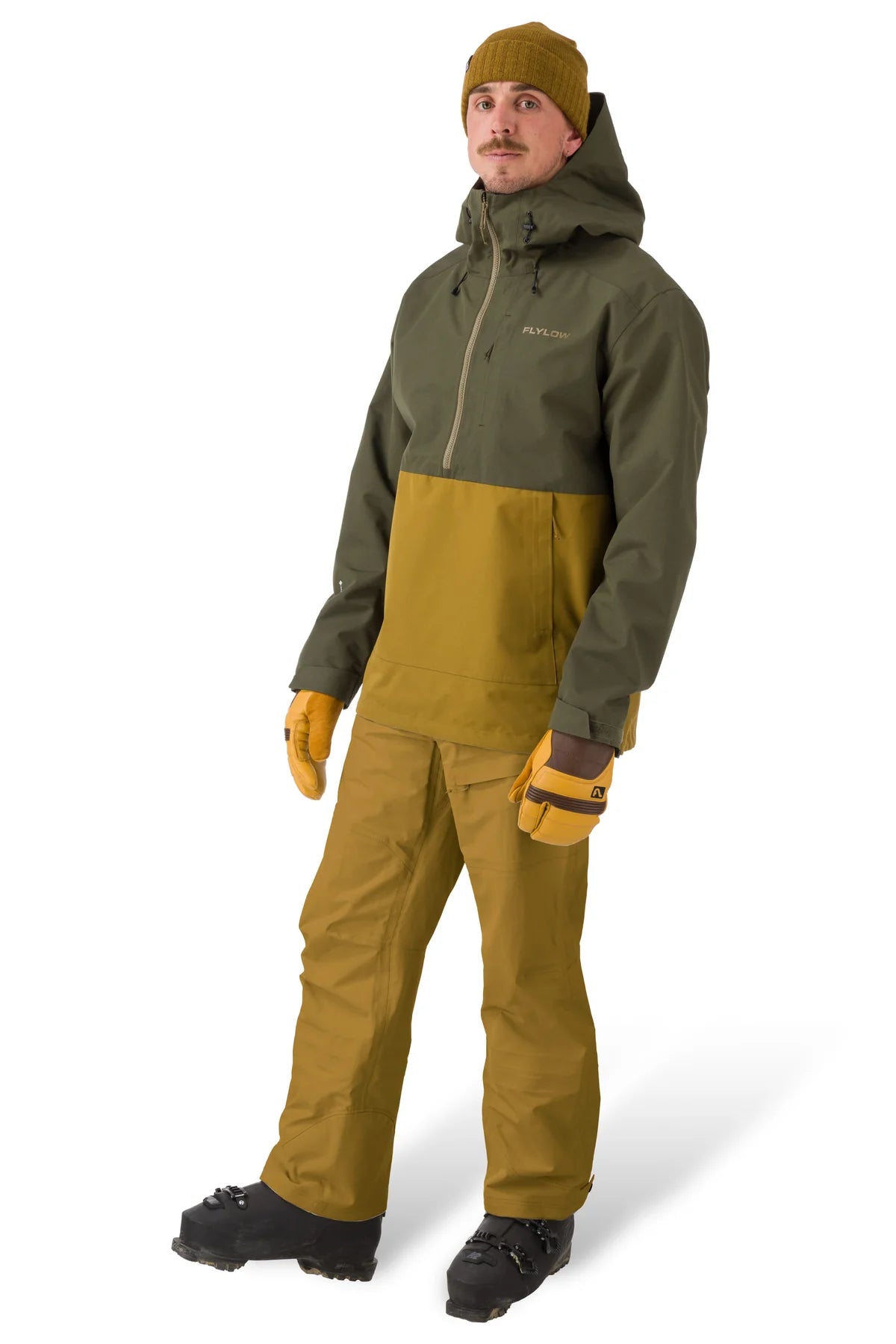 Flylow Knight Anorak Jacket 2025 - A dark green jacket with a hood and zippered pockets, featuring a prominent "FLYLOW" logo on the chest in lighter green.