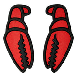 Crab Grab Mega Claw Stomp Pad 2025 - A red crab-shaped pad with a black outline and claws, featuring a textured surface.