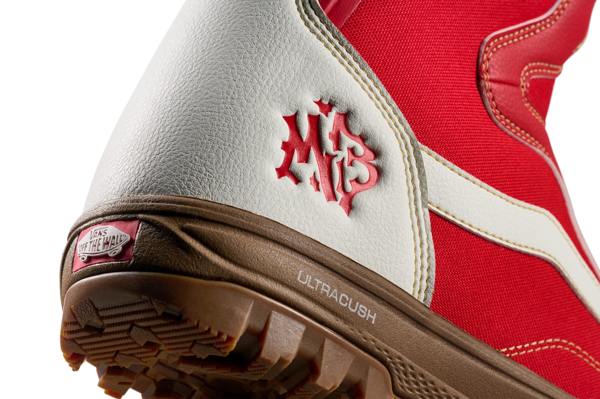 Vans Women's Encore Pro Limited Edition Snowboard Boots 2026 - A pair of snowboard boots with a predominantly white upper and red accents, featuring a distinctive "VANS" logo on the side in red.