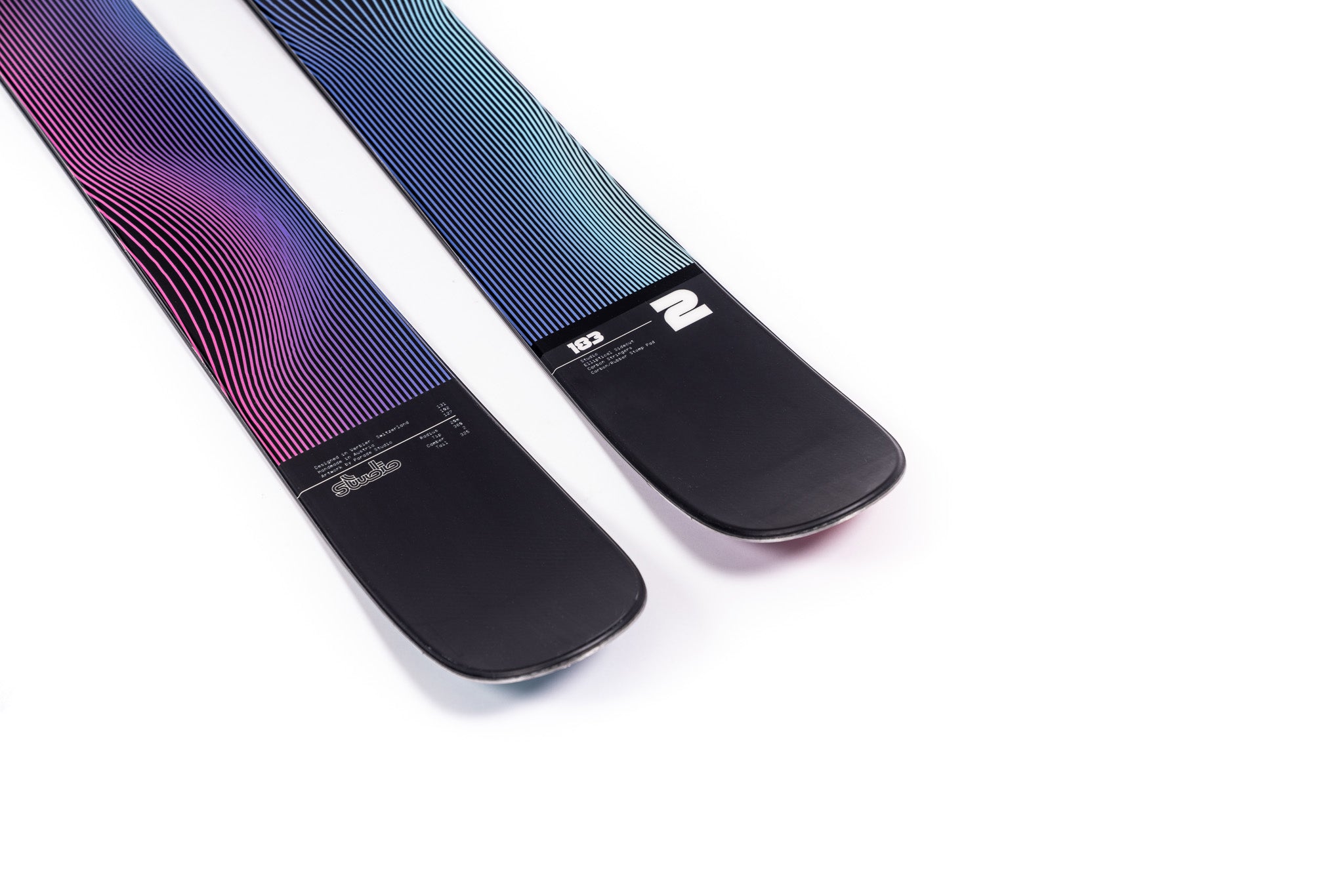 Faction Studio 2 Ski 2025 - A pair of skis with a blue and purple gradient pattern on the top, featuring thin white stripes that curve around the edges.