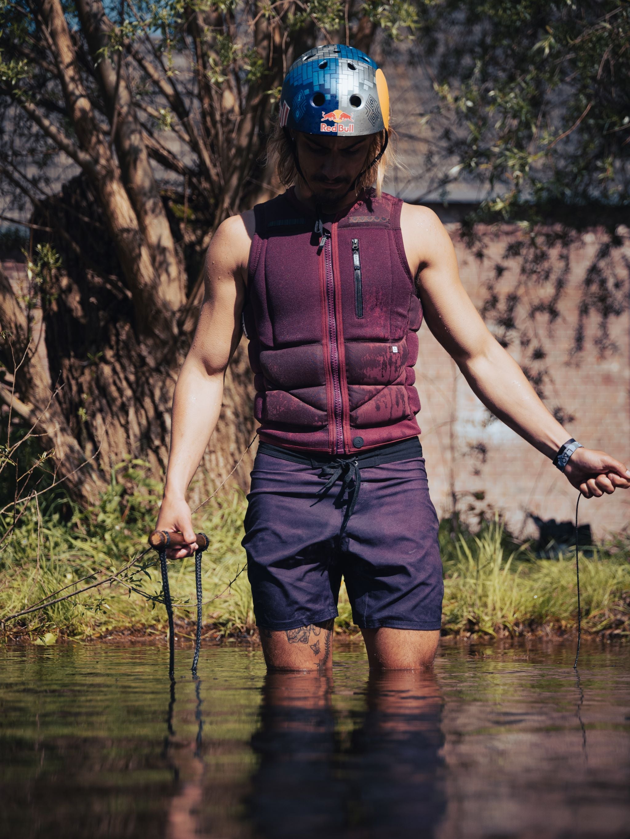 Follow Capiva Impact Vest 2024 - A black vest with a white logo on the chest and straps at the back.