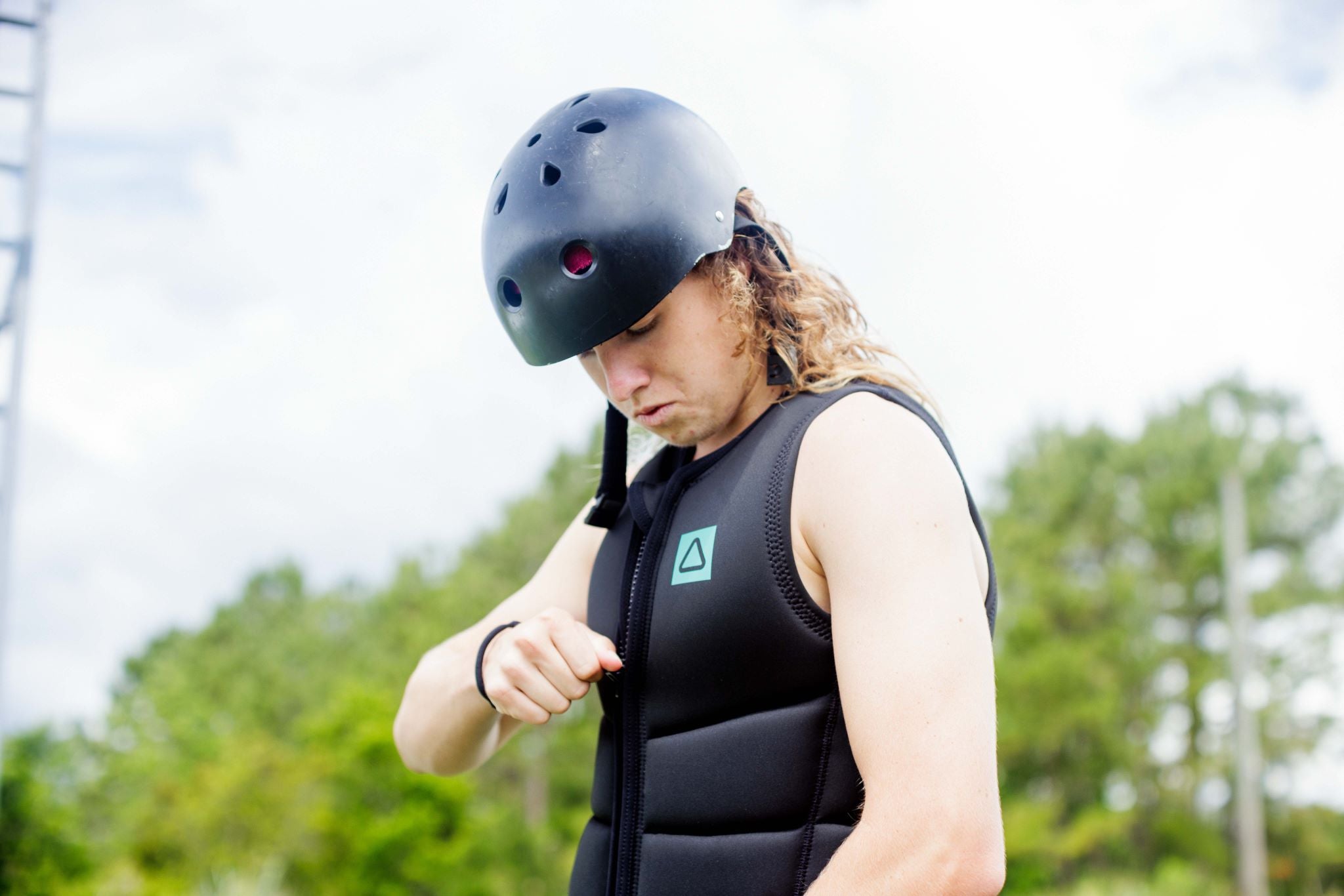 Follow Corp Impact Vest 2024 - Black vest with a green logo on the chest.