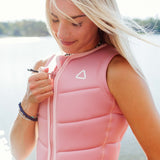 Follow Women's Corp Comp Vest 2024 - A pink women's vest with a white logo on the chest.