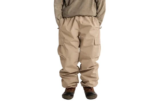Stone cargo shell pants worn, with an elastic waist and flap thigh pockets