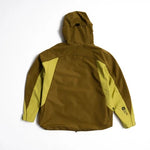 Back view of hooded shell jacket with olive body and yellow-green sleeve panels