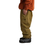 Side view of olive shell pants with a large thigh cargo pocket