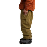 Side view of olive shell pants with a large thigh cargo pocket