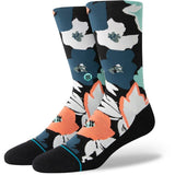 Stance Flower Beds Crew Socks 2024 - A pair of crew socks with a floral pattern in shades of blue, white, and orange on a black background.
