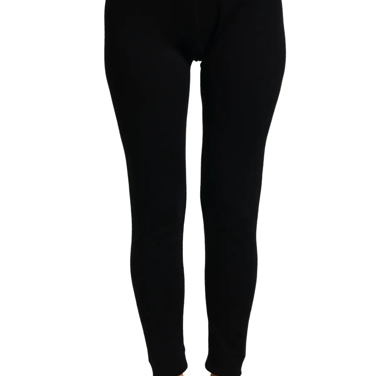 Treviso Women's Merino Pants - A pair of black merino wool pants with a white tag on the right side, worn by a model without shoes or socks.