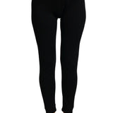 Treviso Women's Merino Pants - A pair of black merino wool pants with a white tag on the right side, worn by a model without shoes or socks.