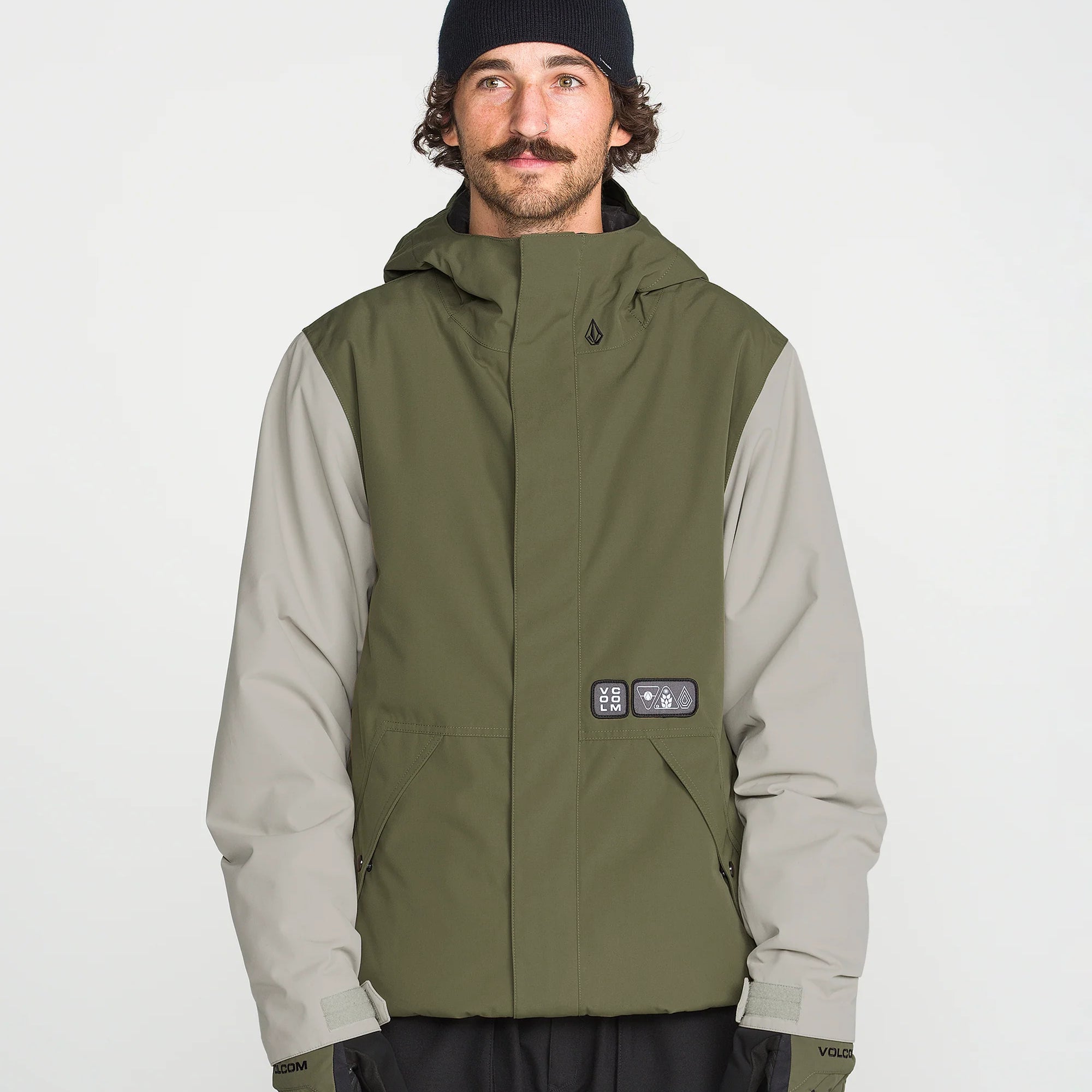 Olive insulated jacket front view with hood, tech patch, and button closure