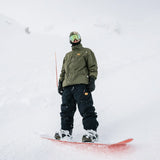 Volcom Longo GORE-TEX Jacket 2025 - A dark green jacket with a hood, worn by a model on a snowy background.