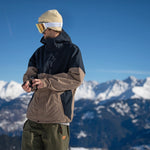 Volcom 2L Insulated GORE-TEX Jacket - A tan and black jacket with a hood, featuring two zippered pockets on the front.