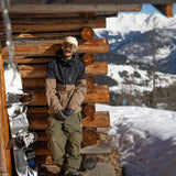 Volcom 2L Insulated GORE-TEX Jacket - A black jacket with a brown chest panel and zipper, featuring a hood and two zippered pockets on the front.