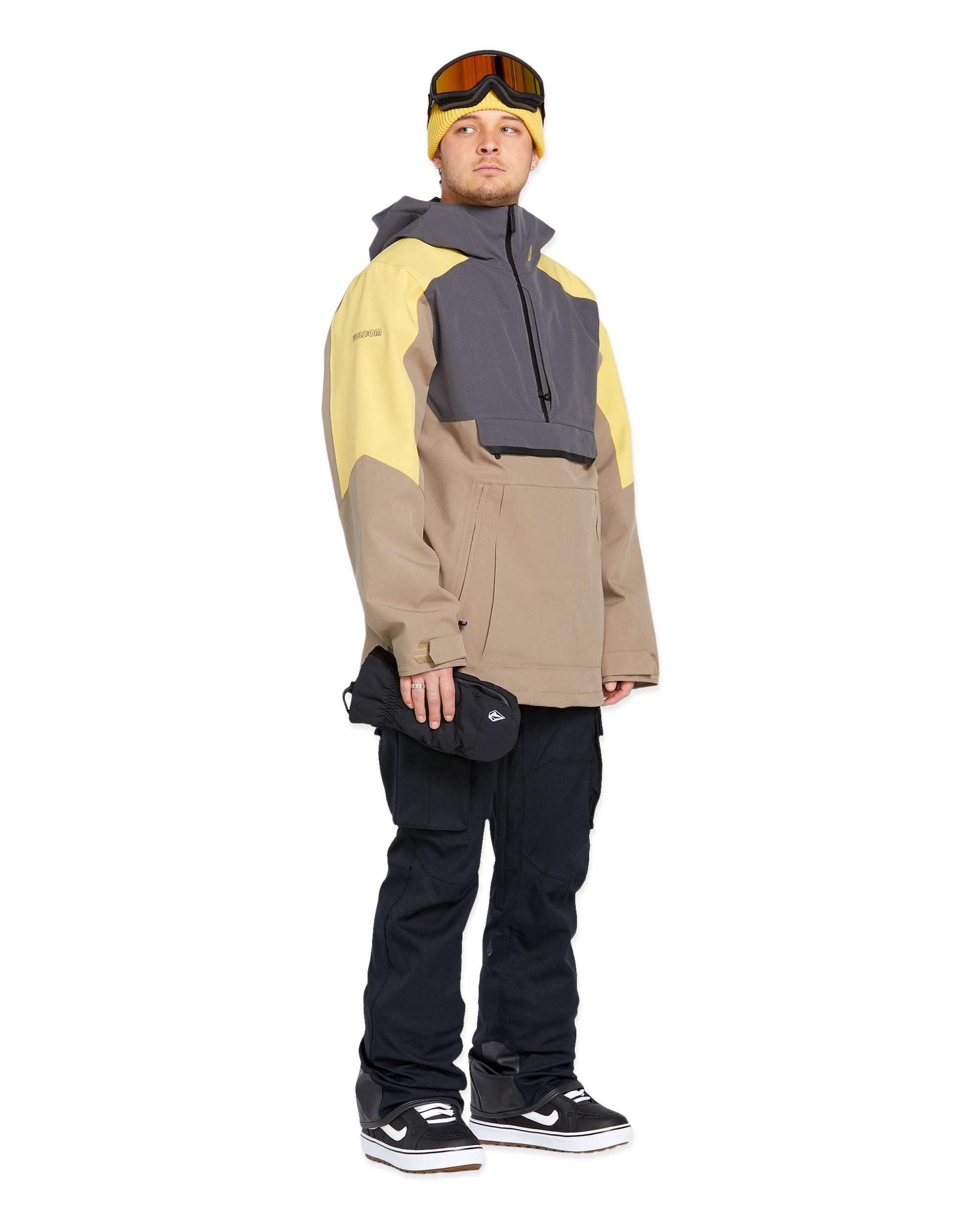 Volcom - A tan jacket with a darker brown patch on the chest, featuring a hood and zip closure.