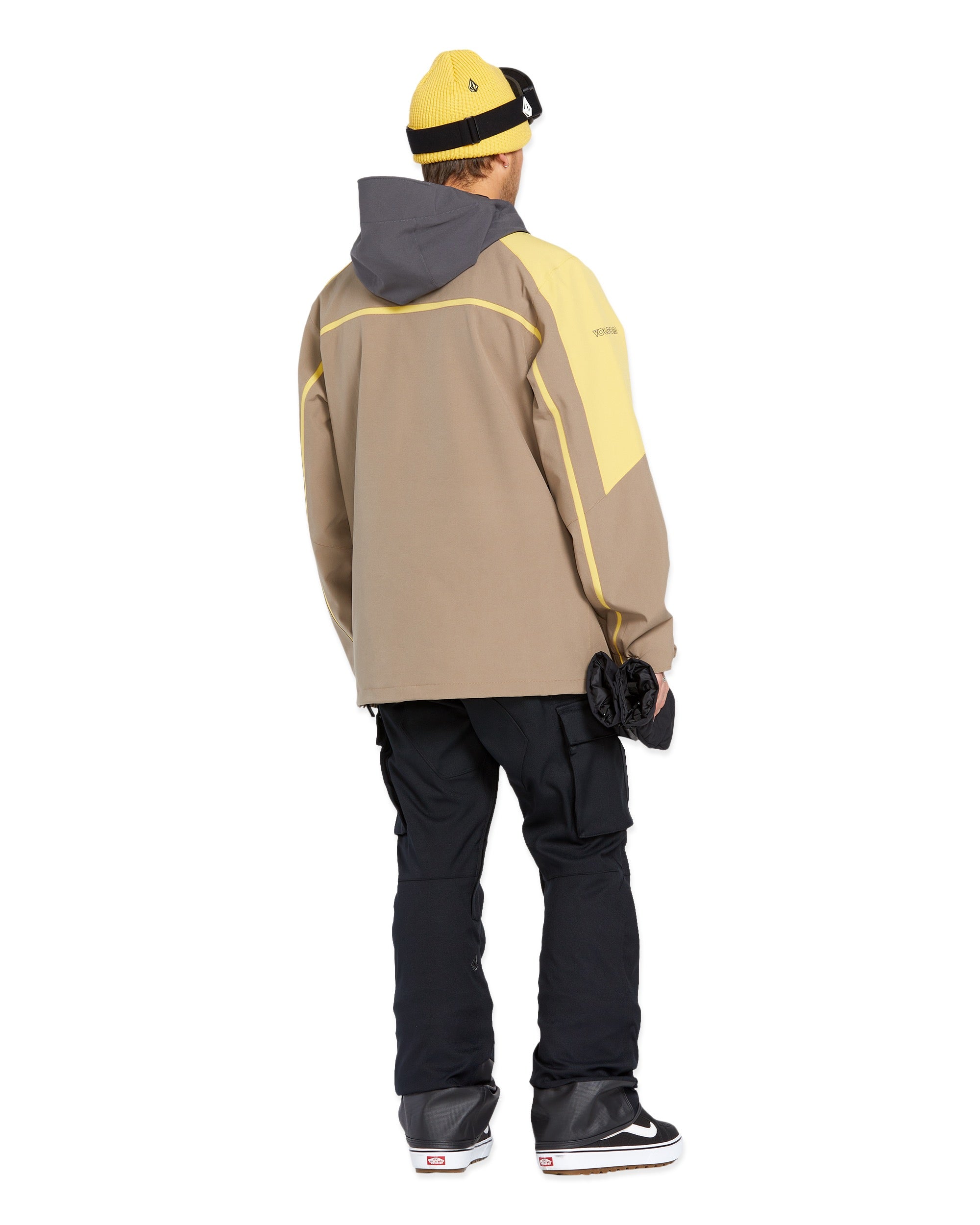 Volcom - A tan jacket with a gray hood, featuring yellow piping along the front and sleeves.