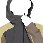 Volcom Brighton Pullover Jacket 2025 - A dark gray jacket with a hood and zippered front, featuring yellow accents on the sleeves.