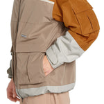 Volcom Nightbreaker 20K Jacket - A tan jacket with a zippered chest pocket and two large cargo pockets on either side, featuring a white zipper pull.