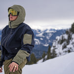 Volcom V.co Wfo Shell Jacket 2025 - A navy blue jacket with olive green accents and a hood, featuring a zipper closure.