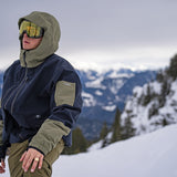 Volcom V.co Wfo Shell Jacket 2025 - A navy blue jacket with olive green accents and a hood, featuring a zipper closure.