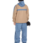 Volcom Longo 20K Pullover Jacket - A tan jacket with a blue stripe across the chest and a hood, featuring a zippered front and two side pockets.