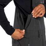 Volcom Men's Rain GORE-TEX Bib Overall - Black bib overall with multiple pockets and a zipper closure.