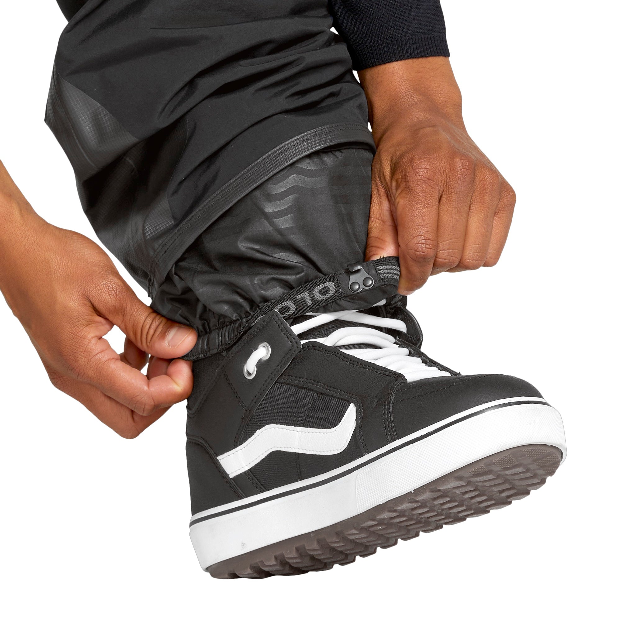 Volcom Men's Rain GORE-TEX Bib Overall - Black bib overall with a white logo on the left thigh and black rain boots.