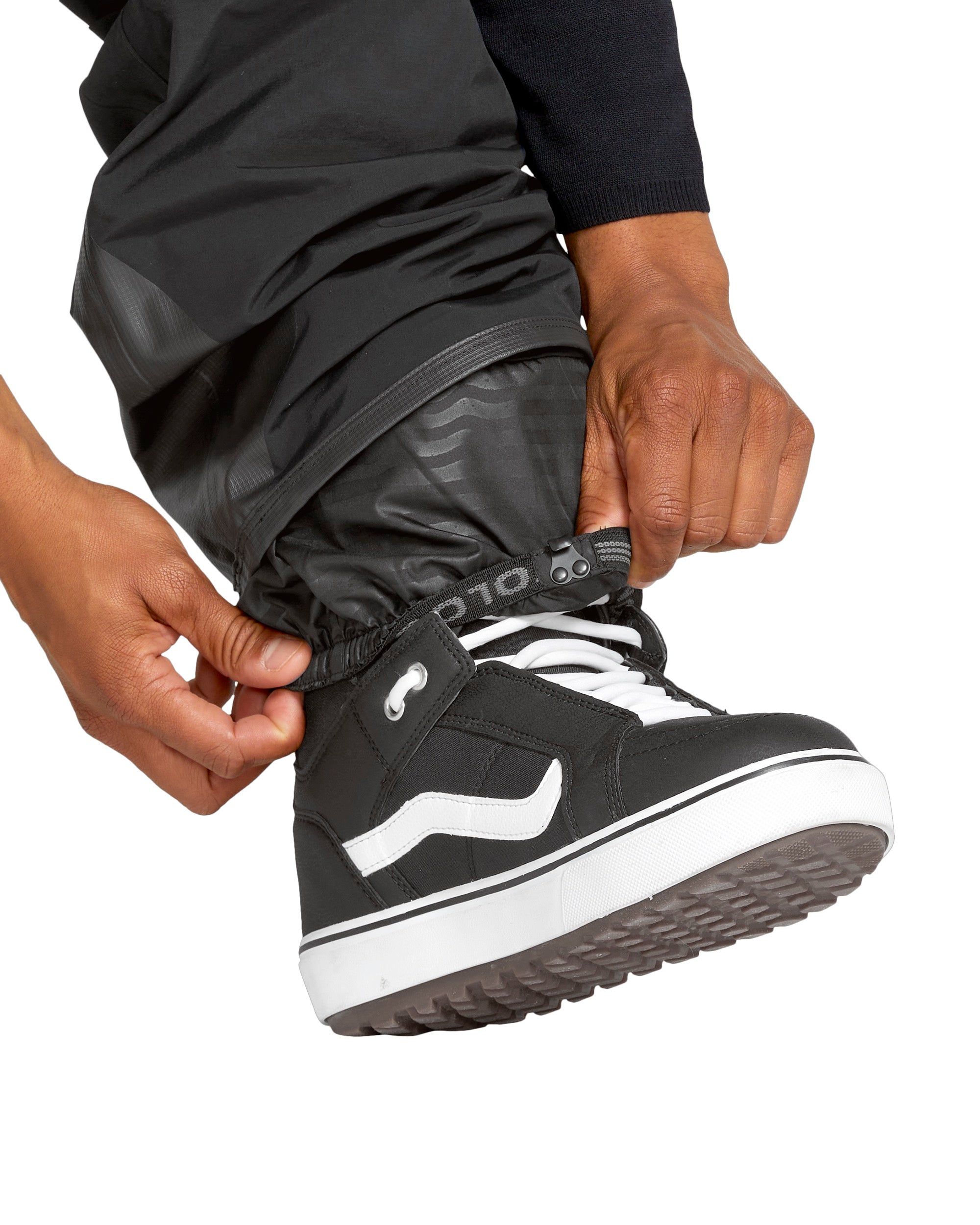 Volcom Men's Rain GORE-TEX Bib Overall - Black bib overall with a white logo on the left thigh and black rain boots.