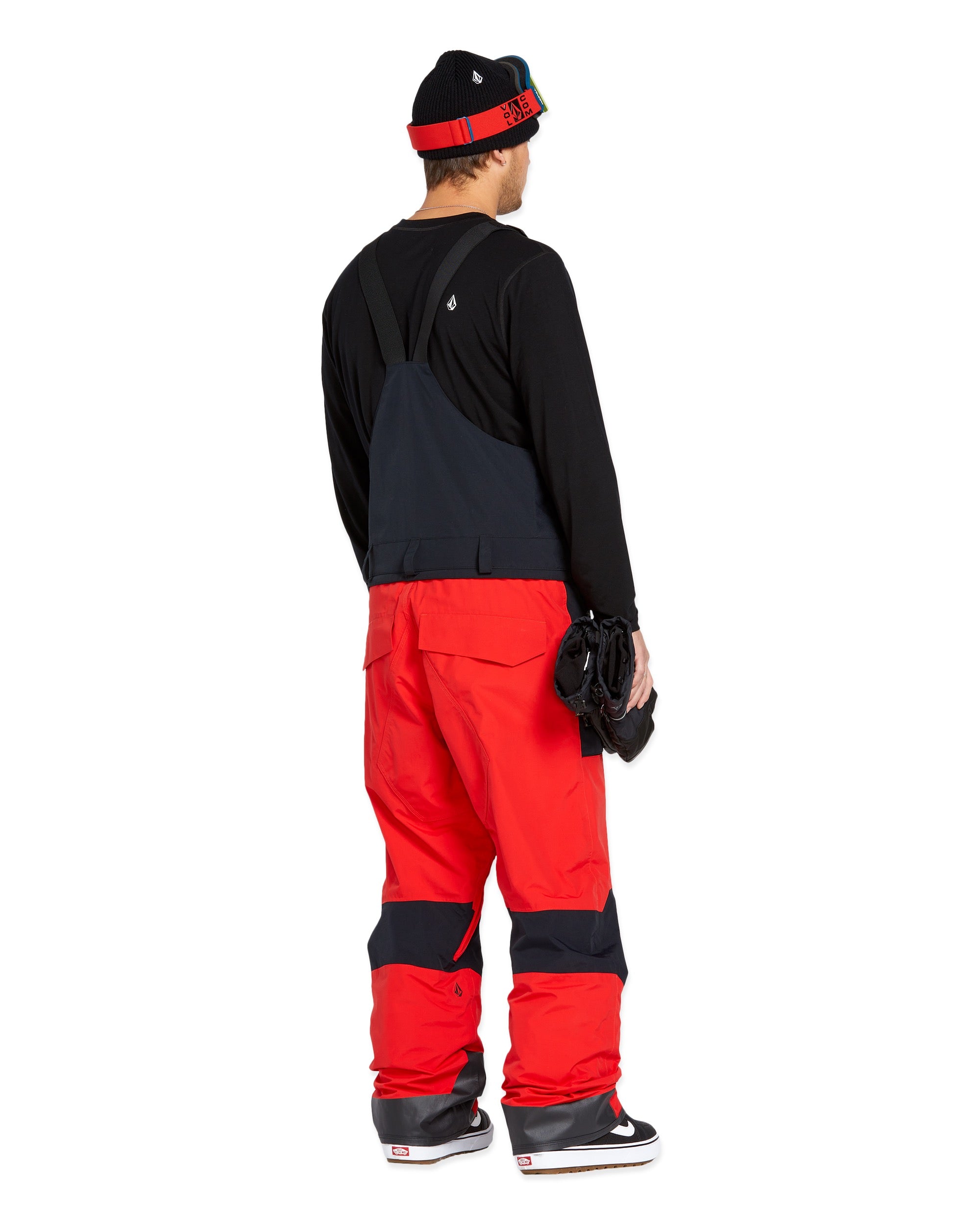 Volcom Men's Rain GORE-TEX Bib Overall - A pair of red and black bib overalls with a rain jacket attached, featuring adjustable straps and pockets on the front.