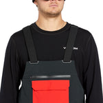 Volcom Men's Rain GORE-TEX Bib Overall - A pair of black waterproof overalls with a red pocket on the front.