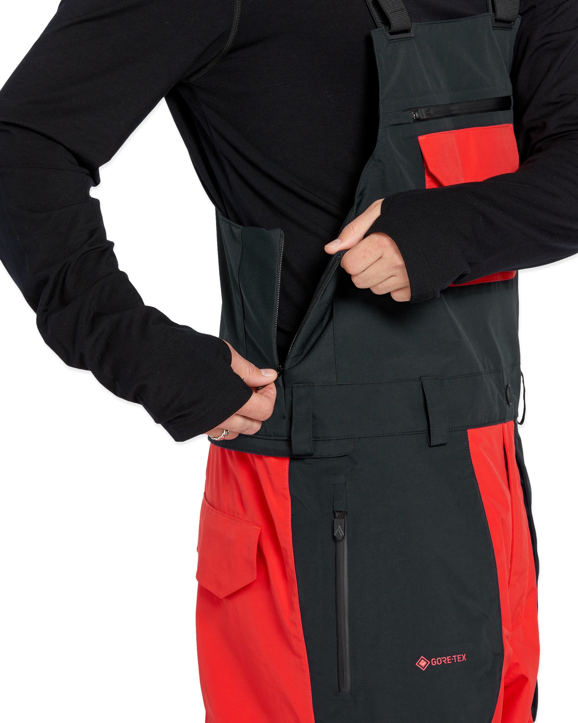 Volcom Men's Rain GORE-TEX Bib Overall - A black bib overall with a red stripe down the side and a zipper on the front.