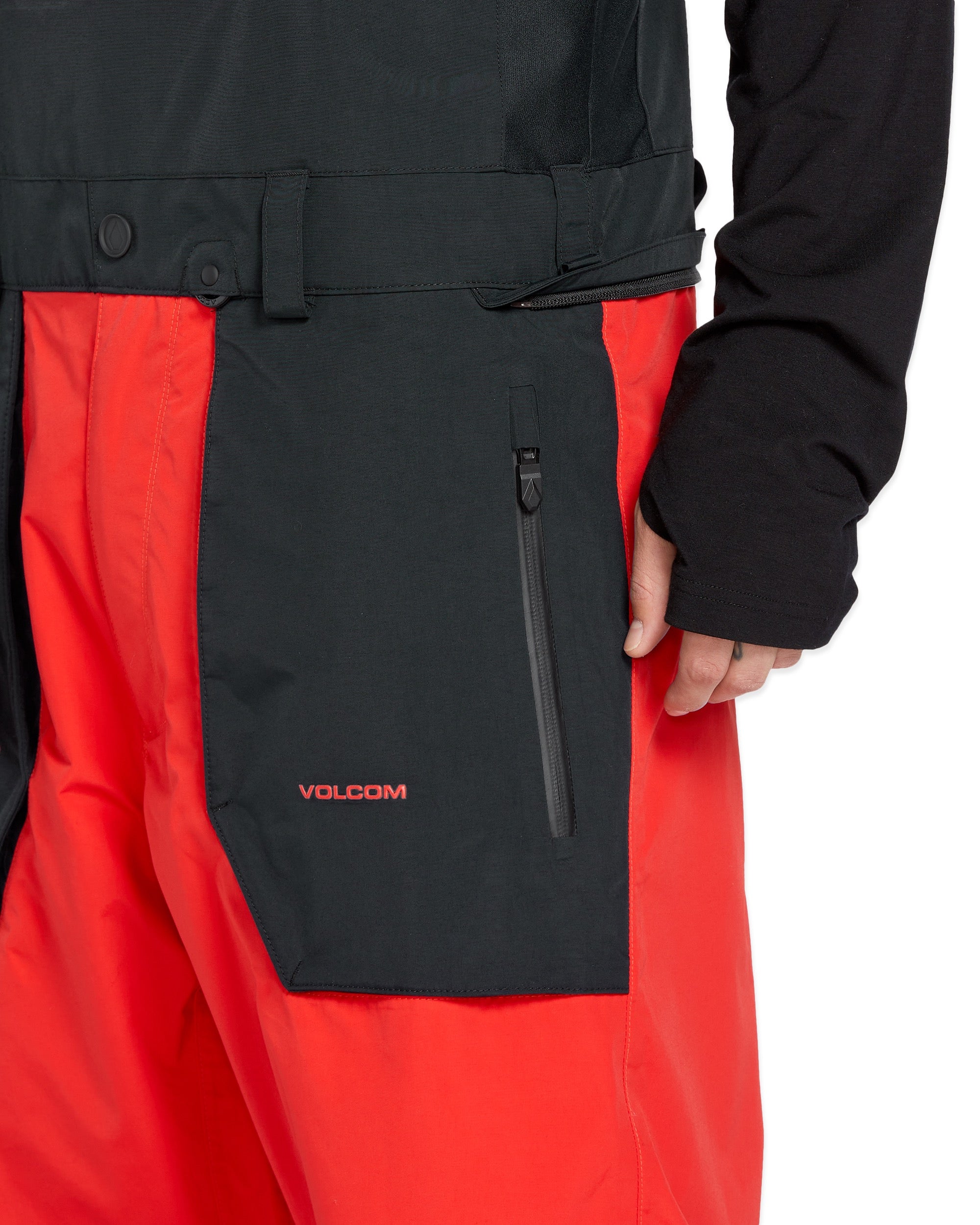 Volcom Men's Rain GORE-TEX Bib Overall - A black bib overall with a red stripe down the side and a zipper on the left leg.