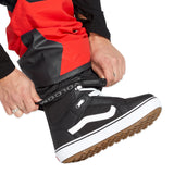 Volcom Men's Rain GORE-TEX Bib Overall - A pair of black rain pants with a red stripe down the side, featuring a zipper and button fly closure.
