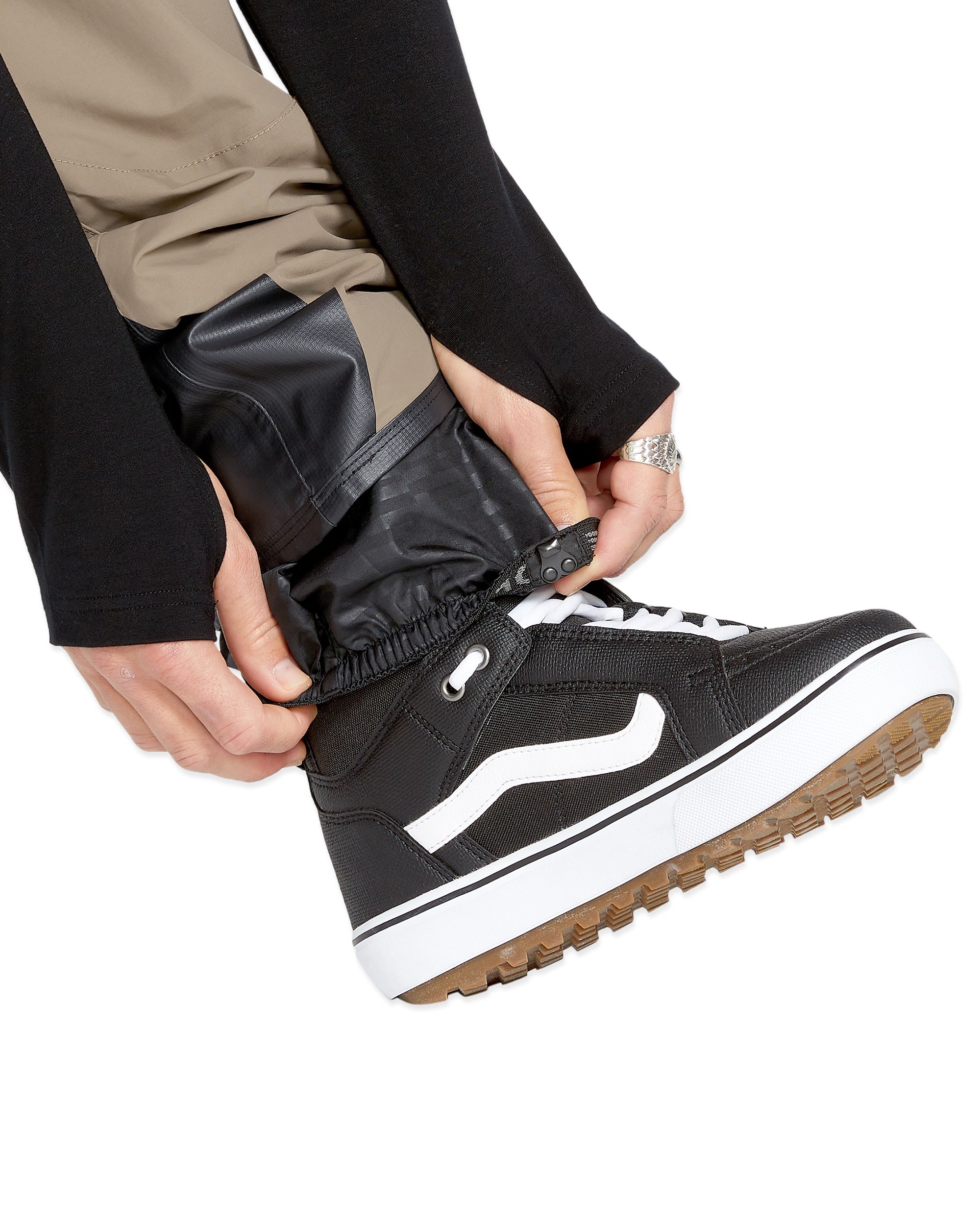 Volcom Men's Rain GORE-TEX Bib Overall - A pair of black rain pants with a white logo on the left leg, featuring a zipper fly and adjustable cuffs.