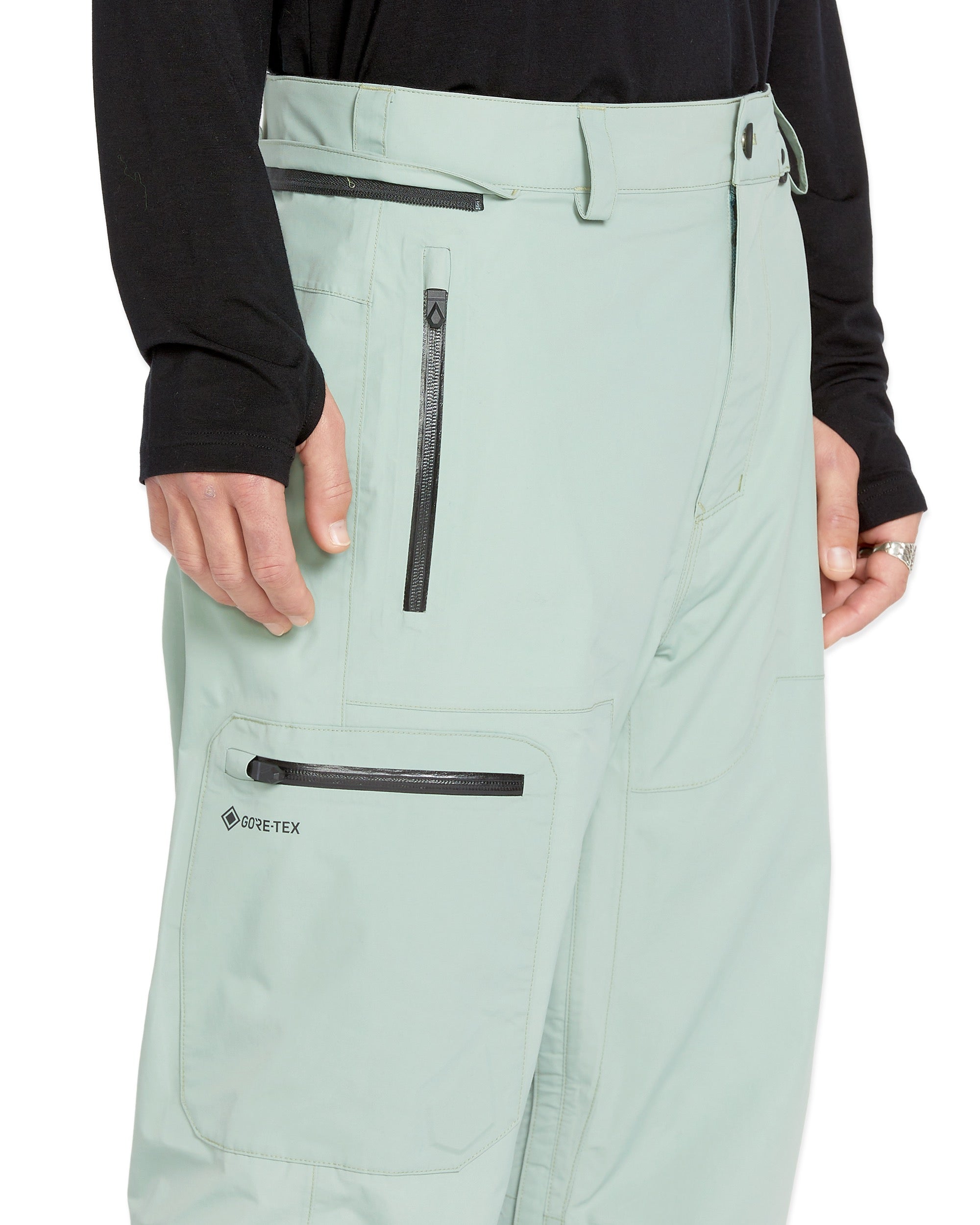 Volcom Men's L GORE-TEX Shell Pant 2025 - A pair of light green snow pants with a black zipper on the side and a black logo that says "GORE-TEX" in white letters.