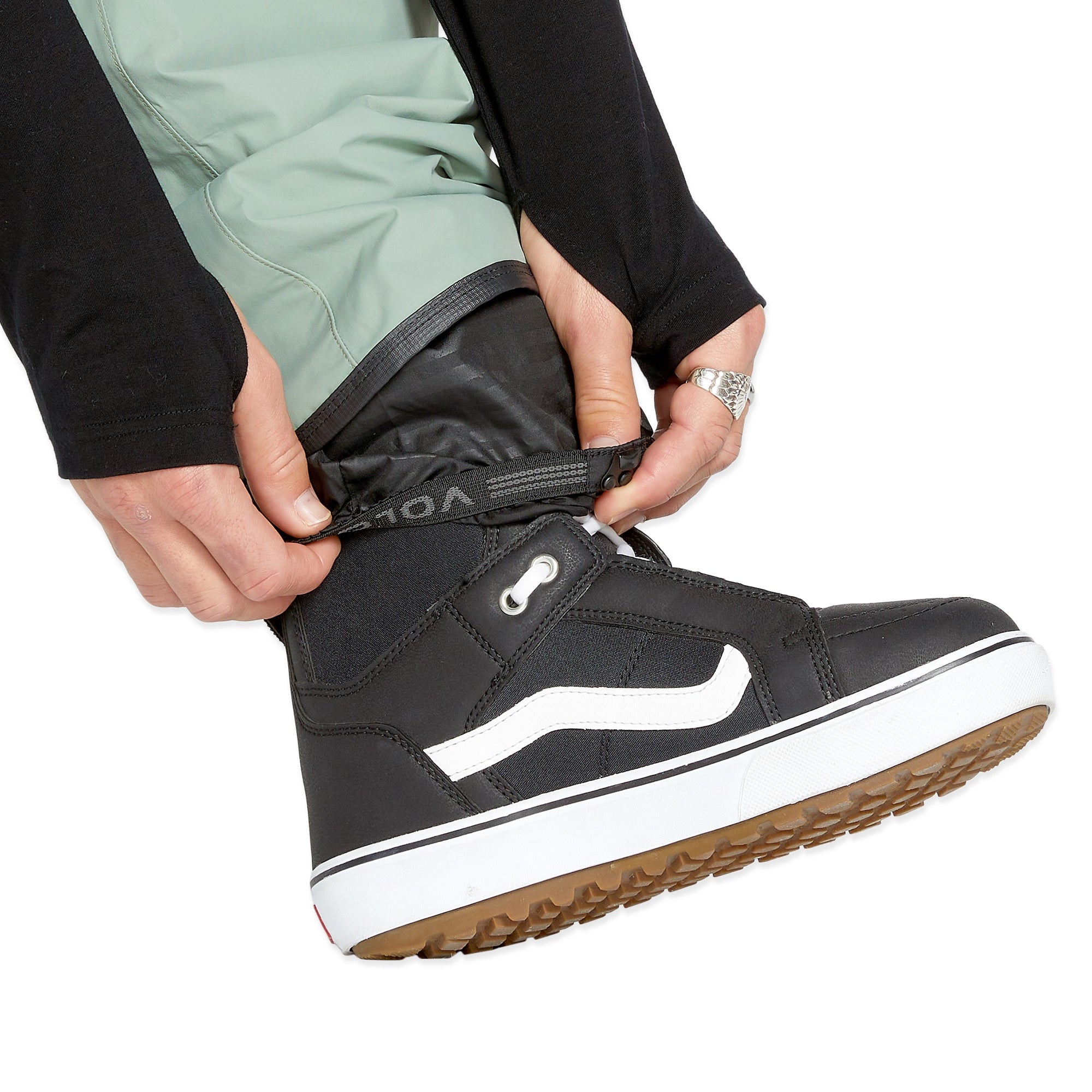 Volcom Men's L GORE-TEX Shell Pant - A pair of black pants with a white logo on the left leg, featuring a zippered fly and adjustable cuffs.