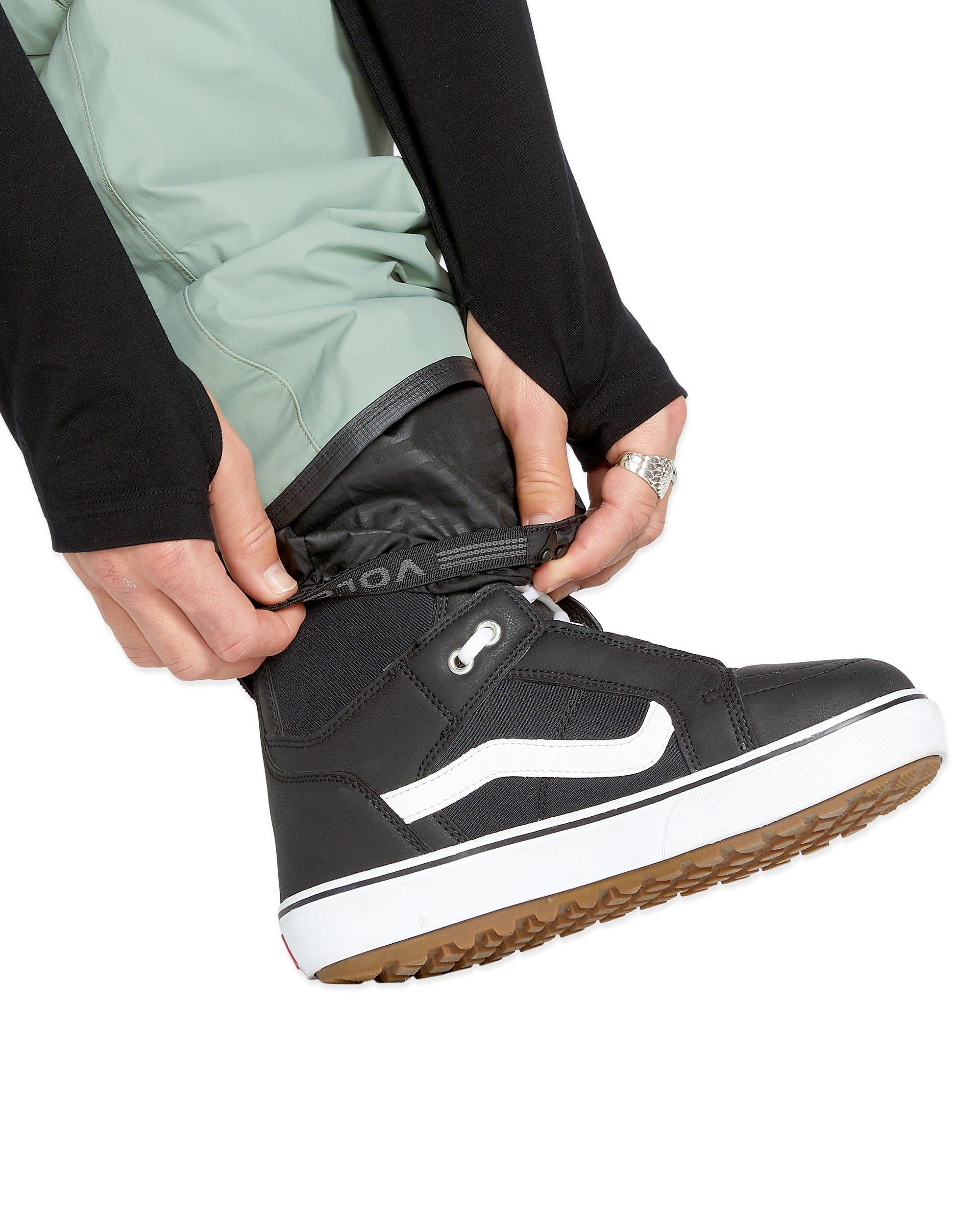 Volcom Men's L GORE-TEX Shell Pant - A pair of black pants with a white logo on the left leg, featuring a zippered fly and adjustable cuffs.