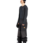 Volcom Men's Longo GORE-TEX Shell Pants - Black pants with a brown logo on the left leg and two zippered pockets on the right side.