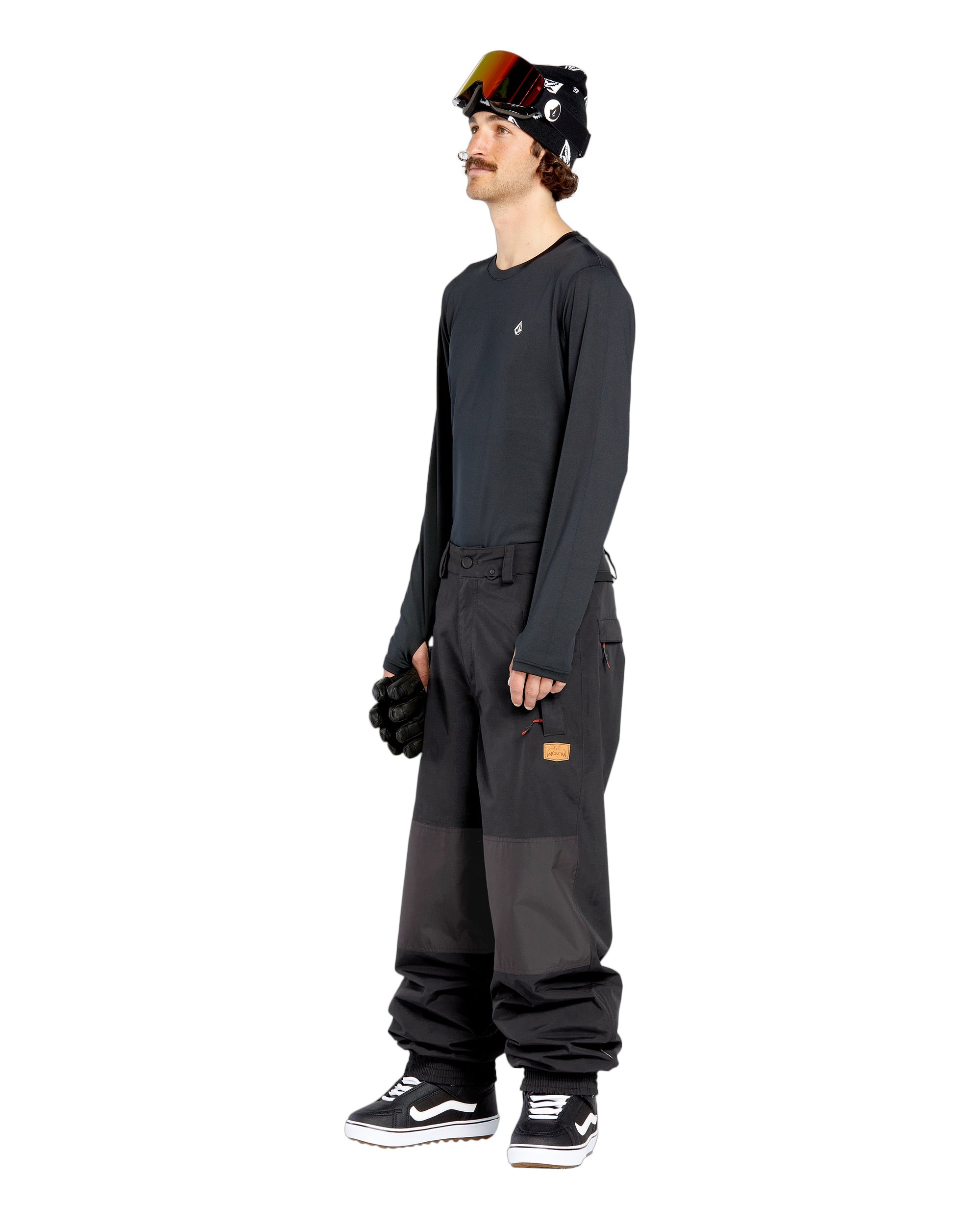 Volcom Men's Longo GORE-TEX Shell Pants - Black pants with a brown logo on the left leg and two zippered pockets on the right side.
