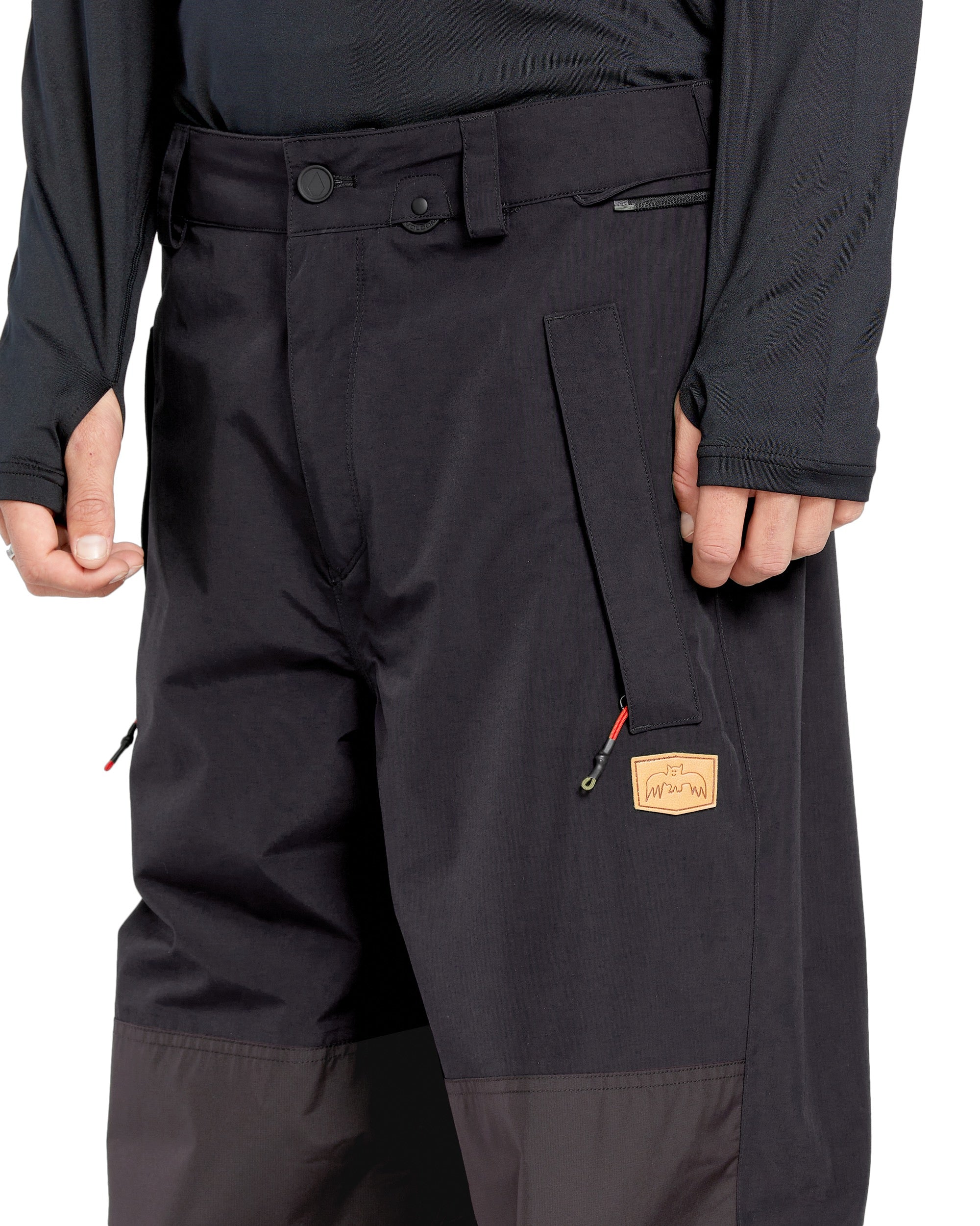 Volcom Men's Longo GORE-TEX Shell Pants - Black pants with a zippered pocket on the right thigh and a black zipper fly.