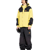 Volcom Men's Longo GORE-TEX Shell Pants - A pair of black snow pants with a brown logo patch on the left thigh.