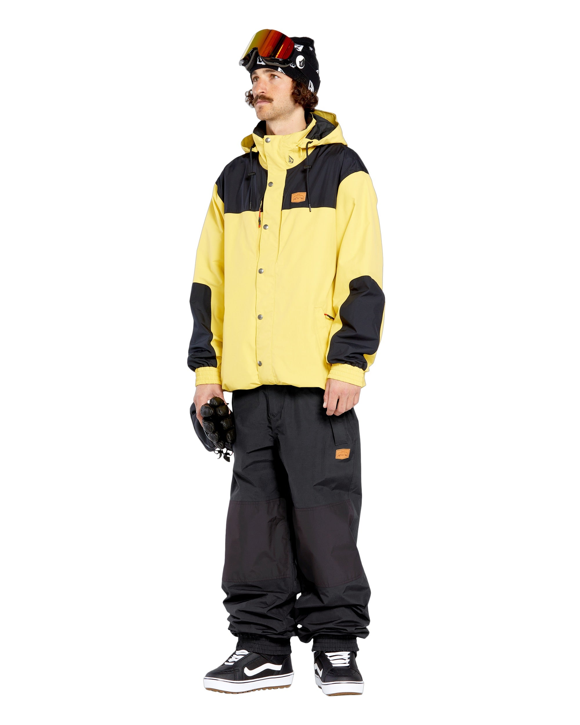 Volcom Men's Longo GORE-TEX Shell Pants - A pair of black snow pants with a brown logo patch on the left thigh.