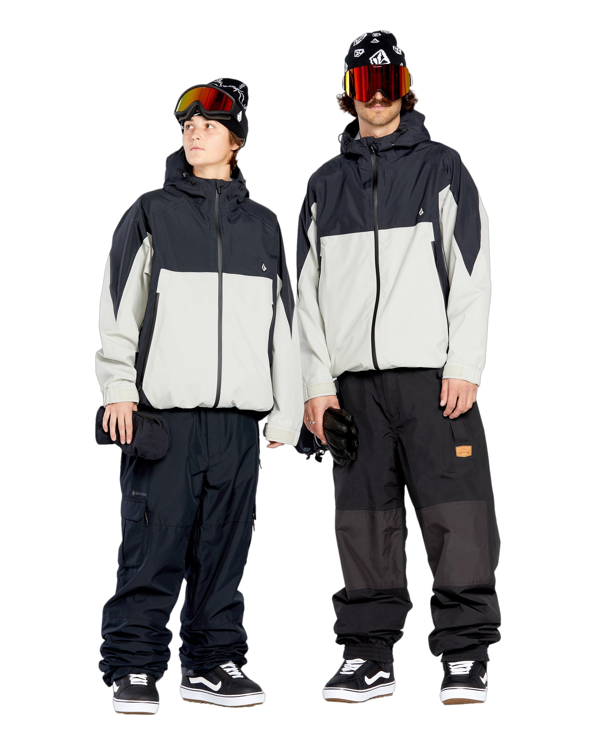 Volcom Men's Longo GORE-TEX Shell Pants - Black pants with a white logo on the left thigh and black zippers on the side pockets.