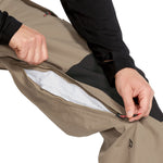 Volcom Men's Longo GORE-TEX Shell Pants - A pair of khaki-colored pants with a zippered fly and two front pockets, featuring a black zipper pull on one pocket.